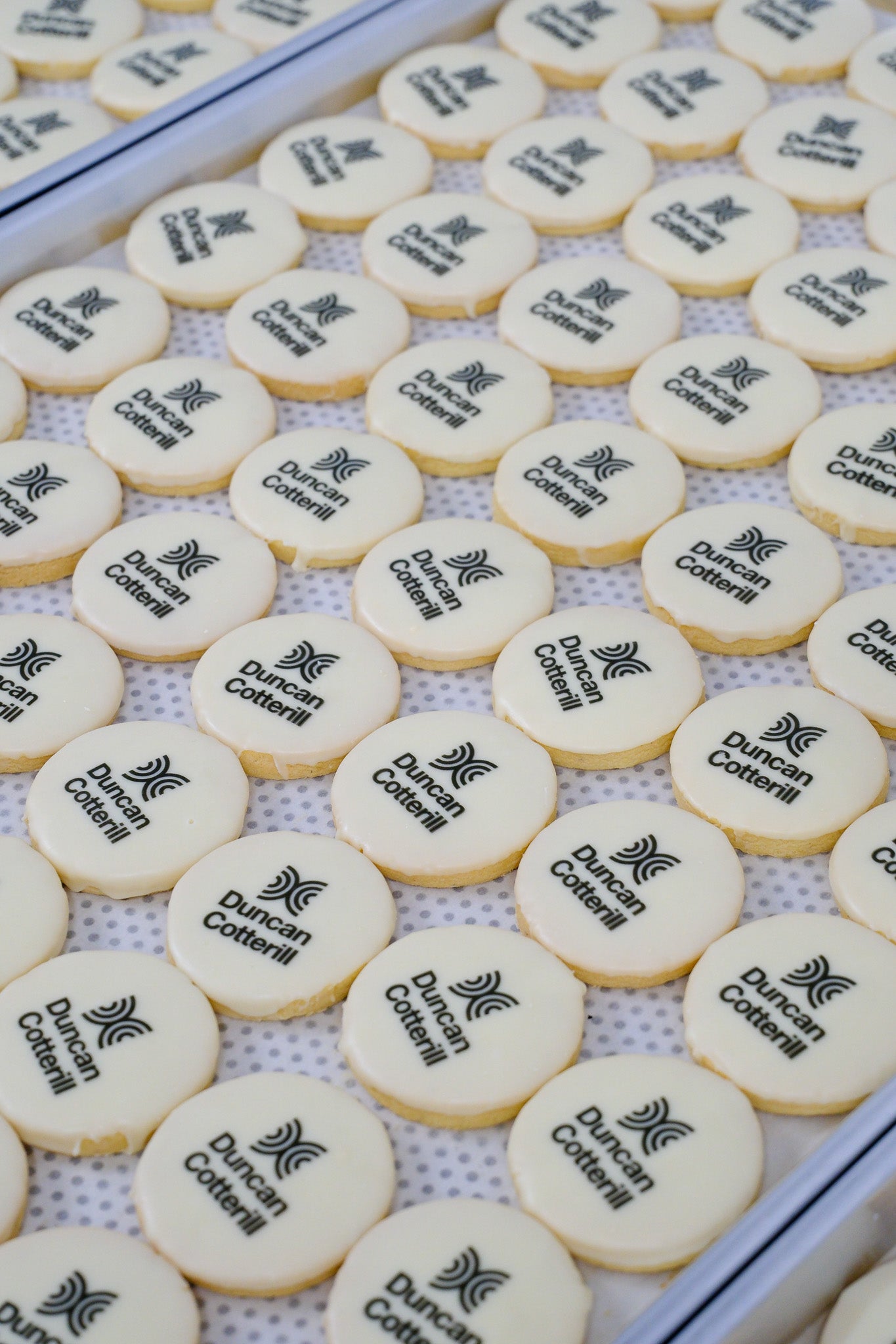 Cookies with Duncan Cottrill logo on a white surface