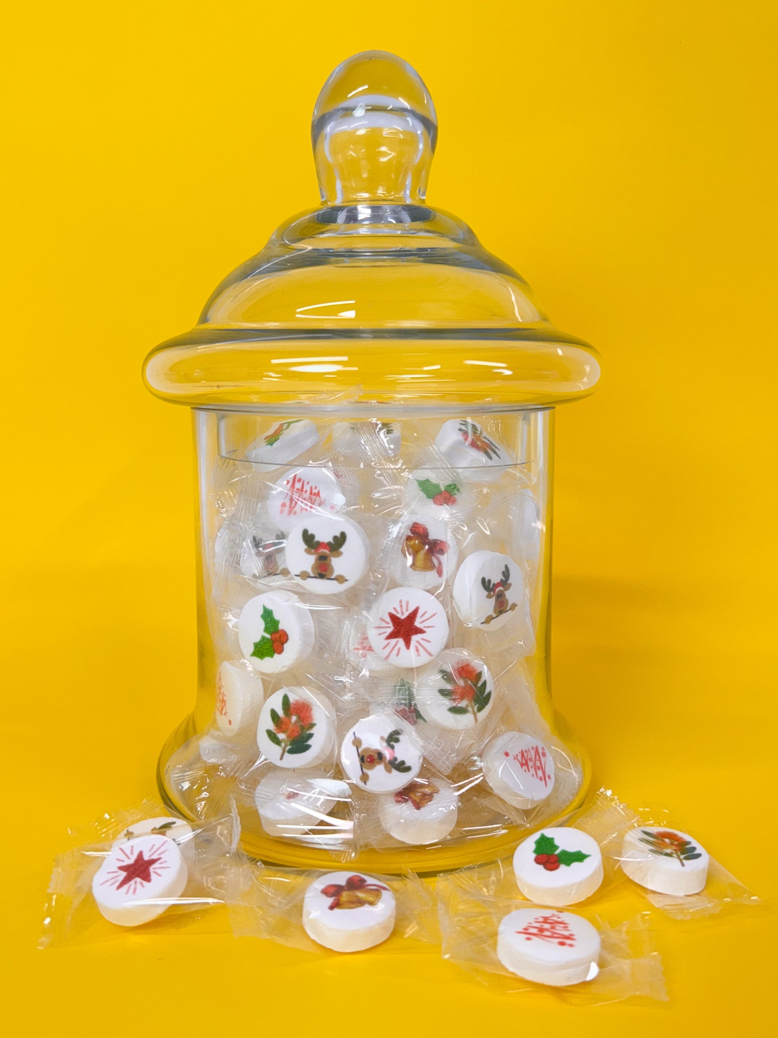 Glass jar with mints on a yellow background